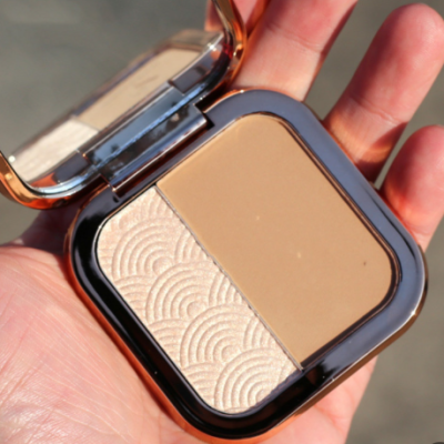Bronzer and highlighter application on face showing natural sun-kissed contoured look