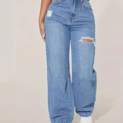 Woman wearing washed ripped hole denim trousers styled with modern streetwear fashion outfit